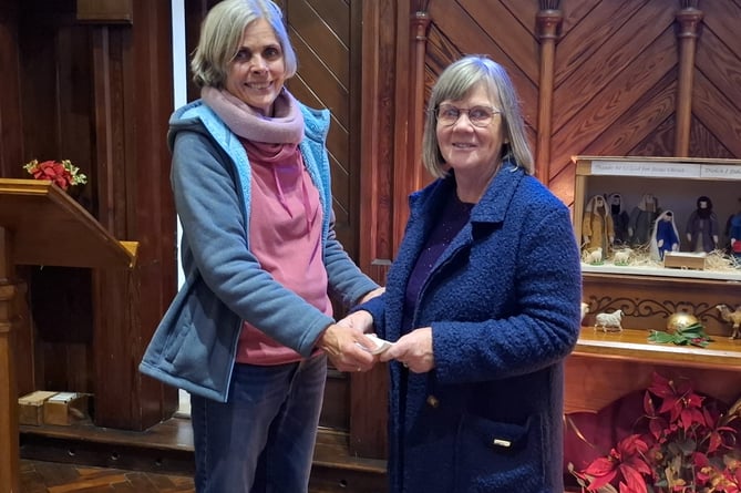 Kathy Rynn, team leader of Aberdyfi Community Lunch, presented Jan with cheques totalling nearly £400