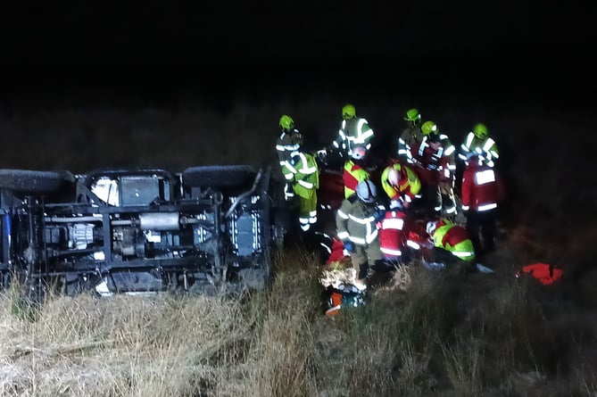 Fire overturned car