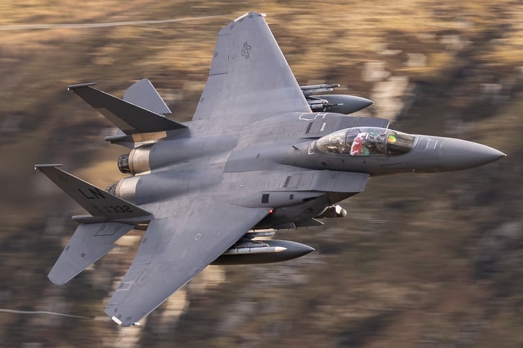 An F-15E Strike Eagle displays a Welsh flag as it flies the mach loop out of RAF Lakenheath. Photo released February 7 2025. The Mach Loop is a set of valleys in Wales near the town of Machynlleth from where it gets its name. The valleys are regularly used for low level flight training down to as low as 250 feet.