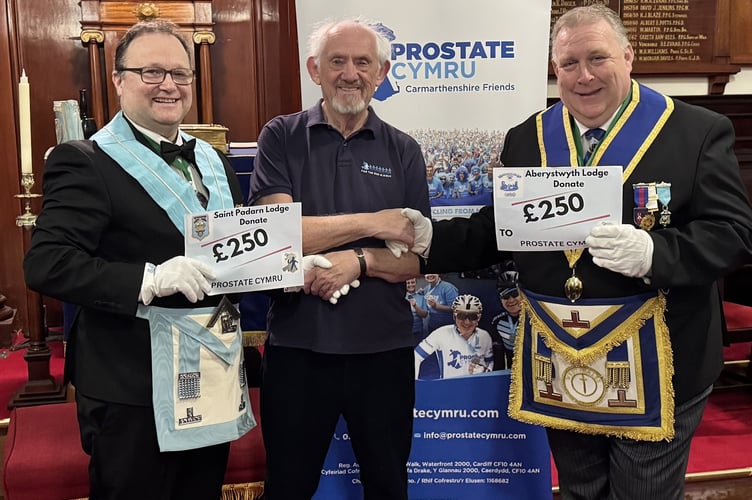 Masons present cheques to Glan Davies from Prostate Cymru