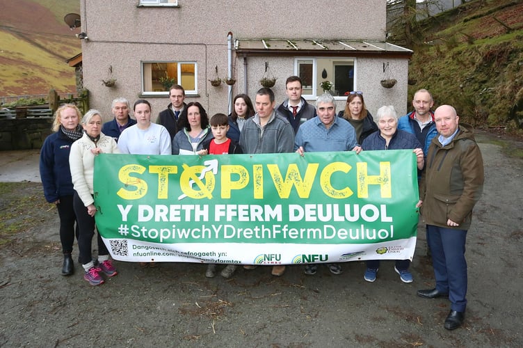 Three generations of the Jones family pictured with Plaid Cymru’s Liz Saville-Roberts MP, Mabon ap Gwynfor MS, NFU Cymru representatives and local businesses outside Ty’n y Braich