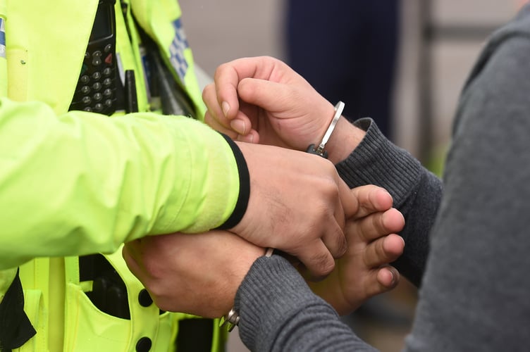 An uninsured driver is handcuffed by police for breach of the peace
